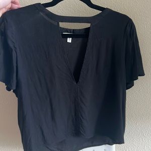Short sleeve shirt with V-neck cut out.